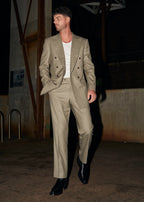 Windsor Olive Suit worn open over a white tank, model walking through a warehouse