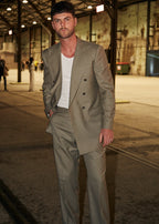 Windsor Olive Suit worn open over a white tank, model facing camera in a warehouse