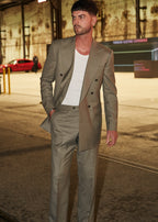Windsor Olive Suit double-breasted jacket worn open over a white tank, warehouse at night