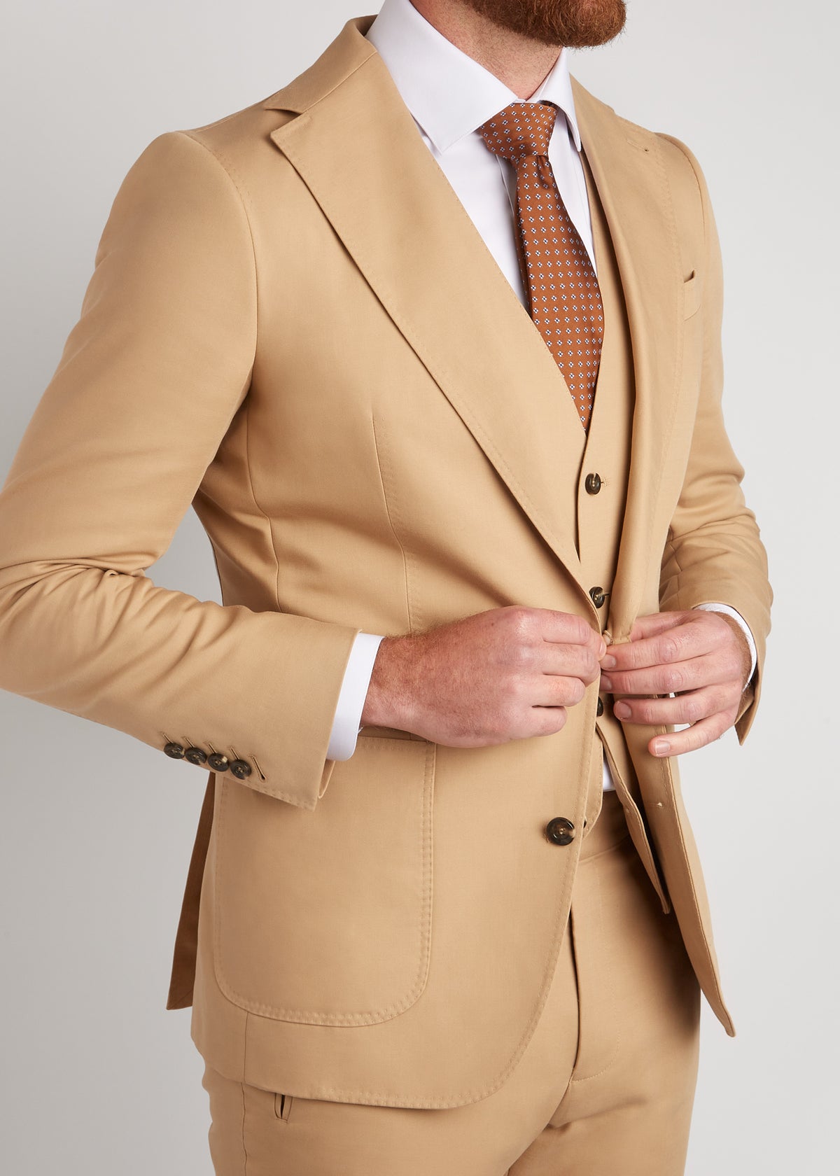 Berkeley Beige Suit, close-up of the lapel as a model fastens the jacket