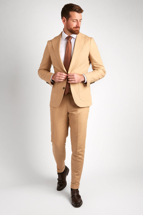 Berkeley Beige Suit, full-length shot of a model walking and adjusting the jacket button