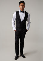 The Great Black Tuxedo waistcoat and trousers, full length front view with hands in pockets