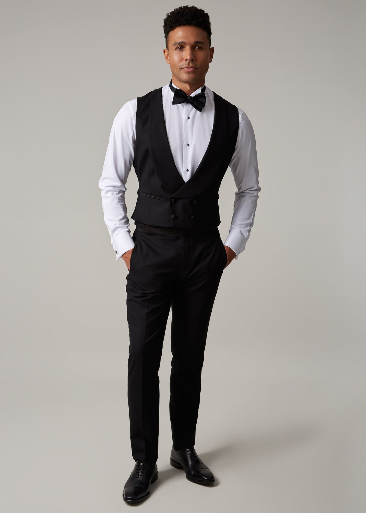 The Great Black Tuxedo waistcoat and trousers, full length front view with hands in pockets