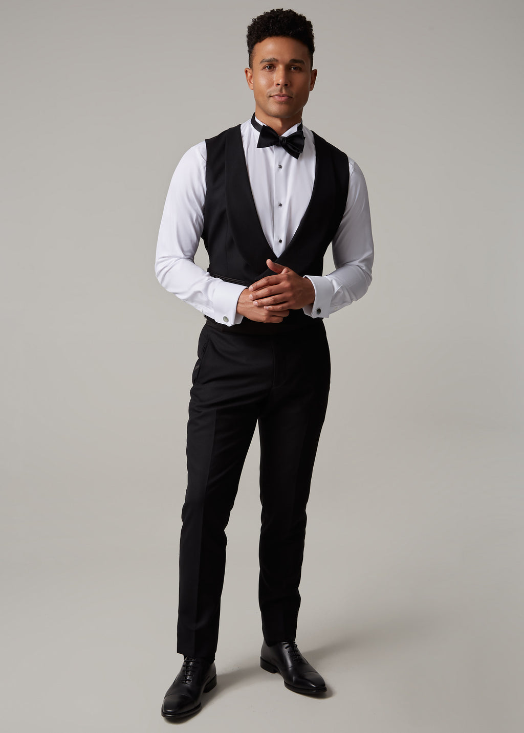 The Great Black Tuxedo waistcoat and trousers, full length front view with hands clasped