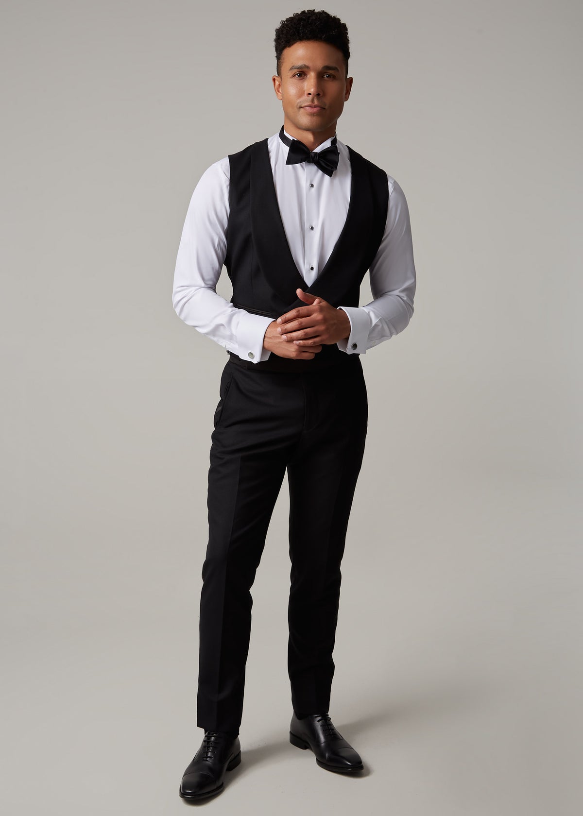 The Great Black Tuxedo waistcoat and trousers, full length front view with hands clasped