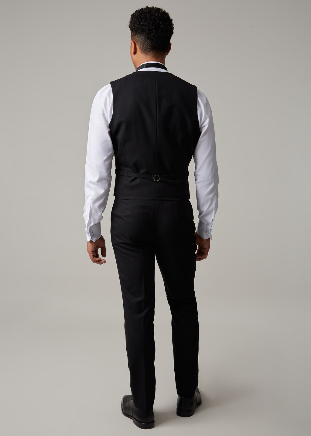 The Great Black Tuxedo waistcoat back view on a model, showing the back strap