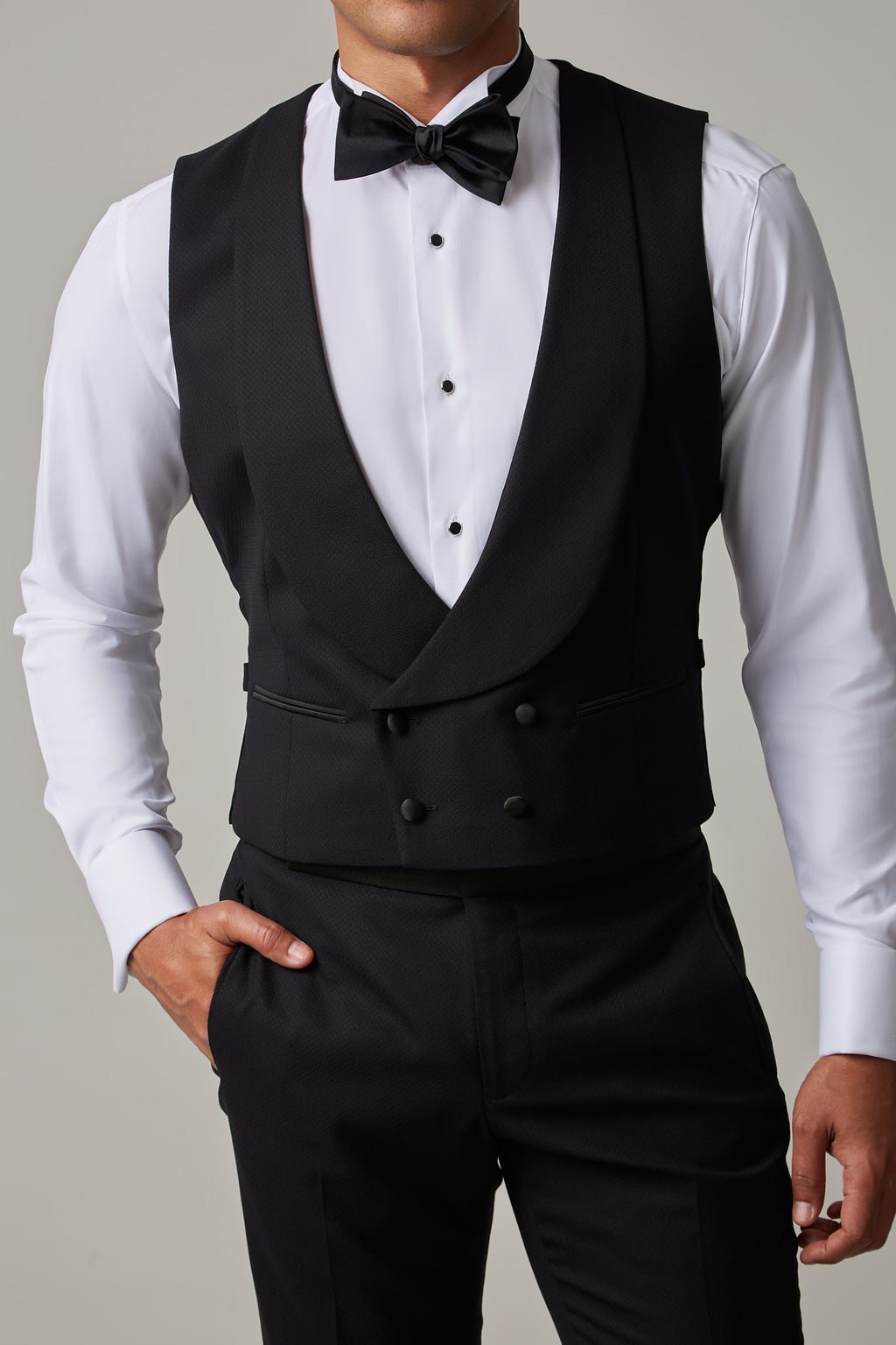 The Great Black Tuxedo waistcoat in shirtsleeves, closer crop front view with hand in pocket