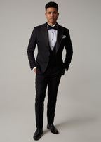 The Great Black Tuxedo jacket buttoned, full front view on a model with hands in pockets