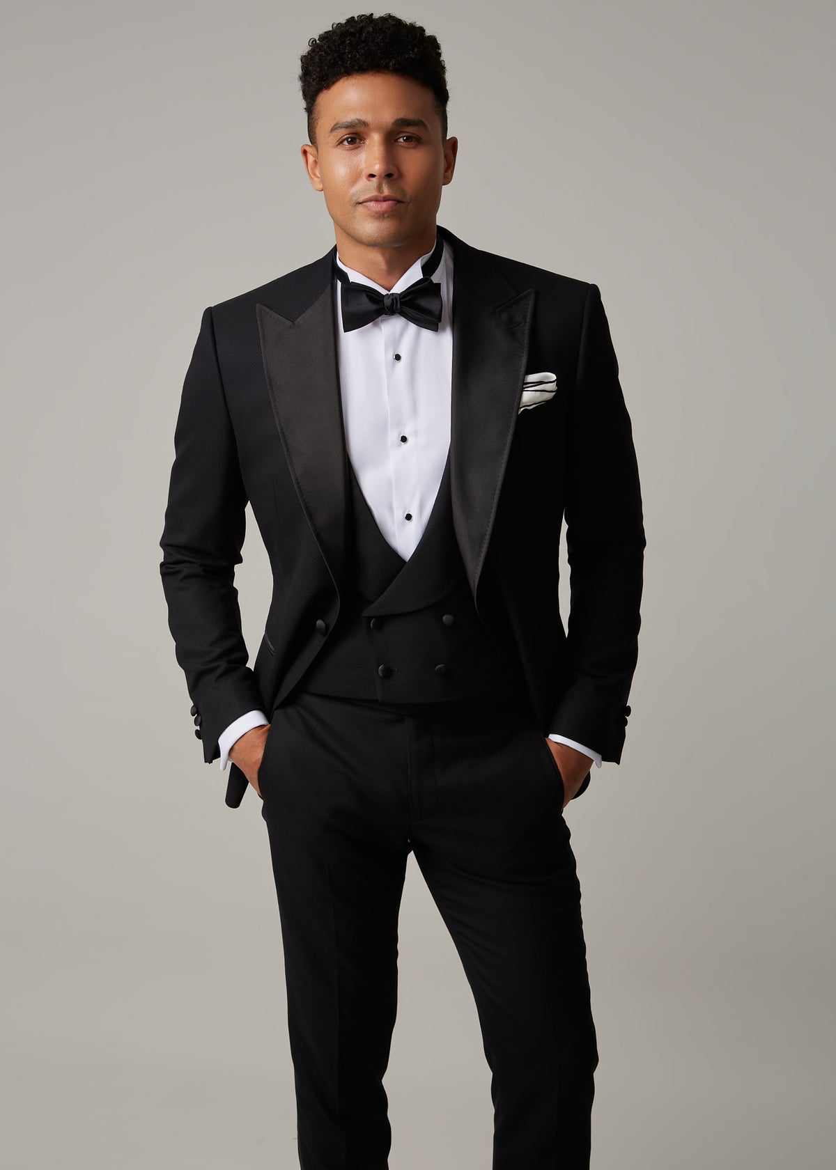 The Great Black Tuxedo jacket open over waistcoat, close crop from the chest with hands in pockets