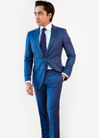 Tokyo Tie in blue micro pattern worn with a blue suit, styled on a model