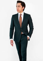 Seoul Tie in brown dotted pattern worn with a dark green suit, model looking aside