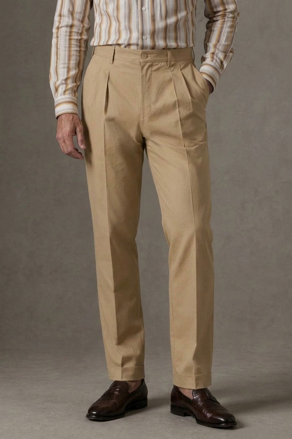 Khaki Box-Pleat Cotton Trousers, front view on a model styled with a striped shirt and dark brown penny loafers