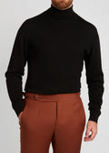Irish Coffee Turtleneck Black worn close-up with rust-toned trousers