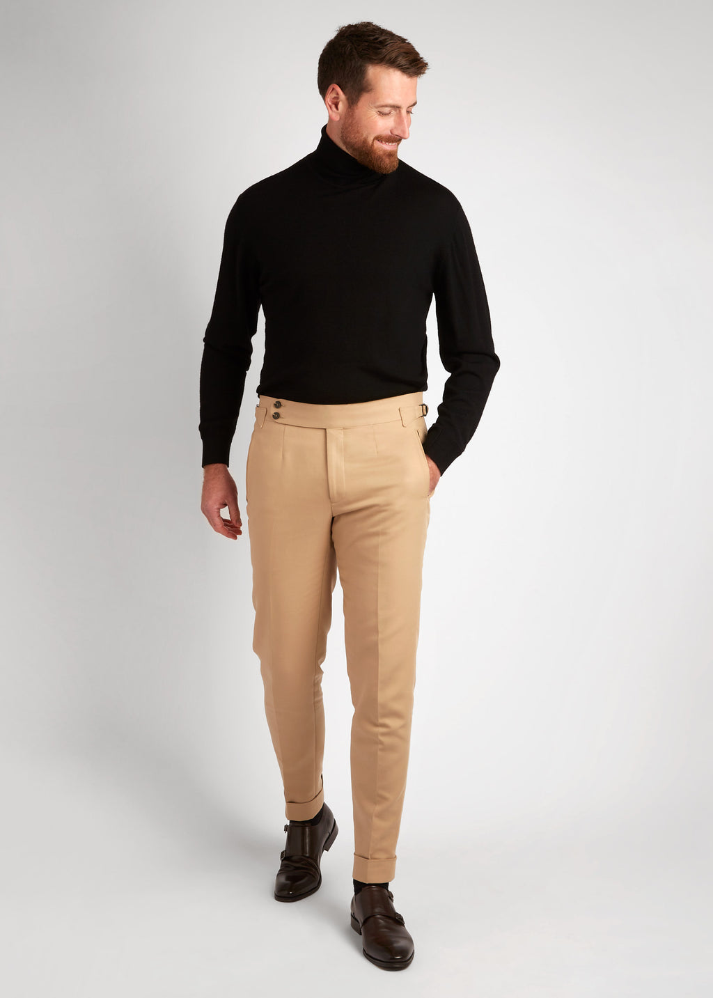 Irish Coffee Turtleneck Black worn with tan trousers, full-length, looking down