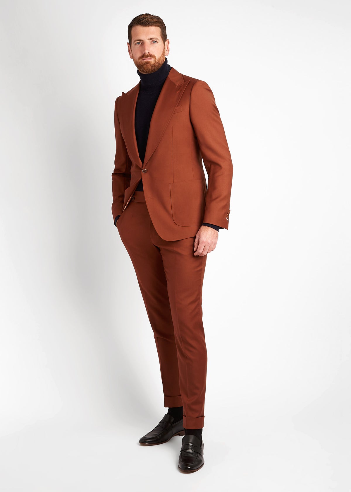 Irish Coffee Turtleneck Navy layered under a rust suit jacket, full-length side angle