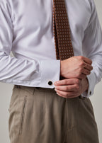 Parkside Light Brown Suit, close-up of shirt cuff and cufflink with hands clasped