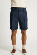 The Byron Navy Wool-Blend Double-Pleat Shorts, front view on a model styled with a cream tee, white socks and tan penny loafers