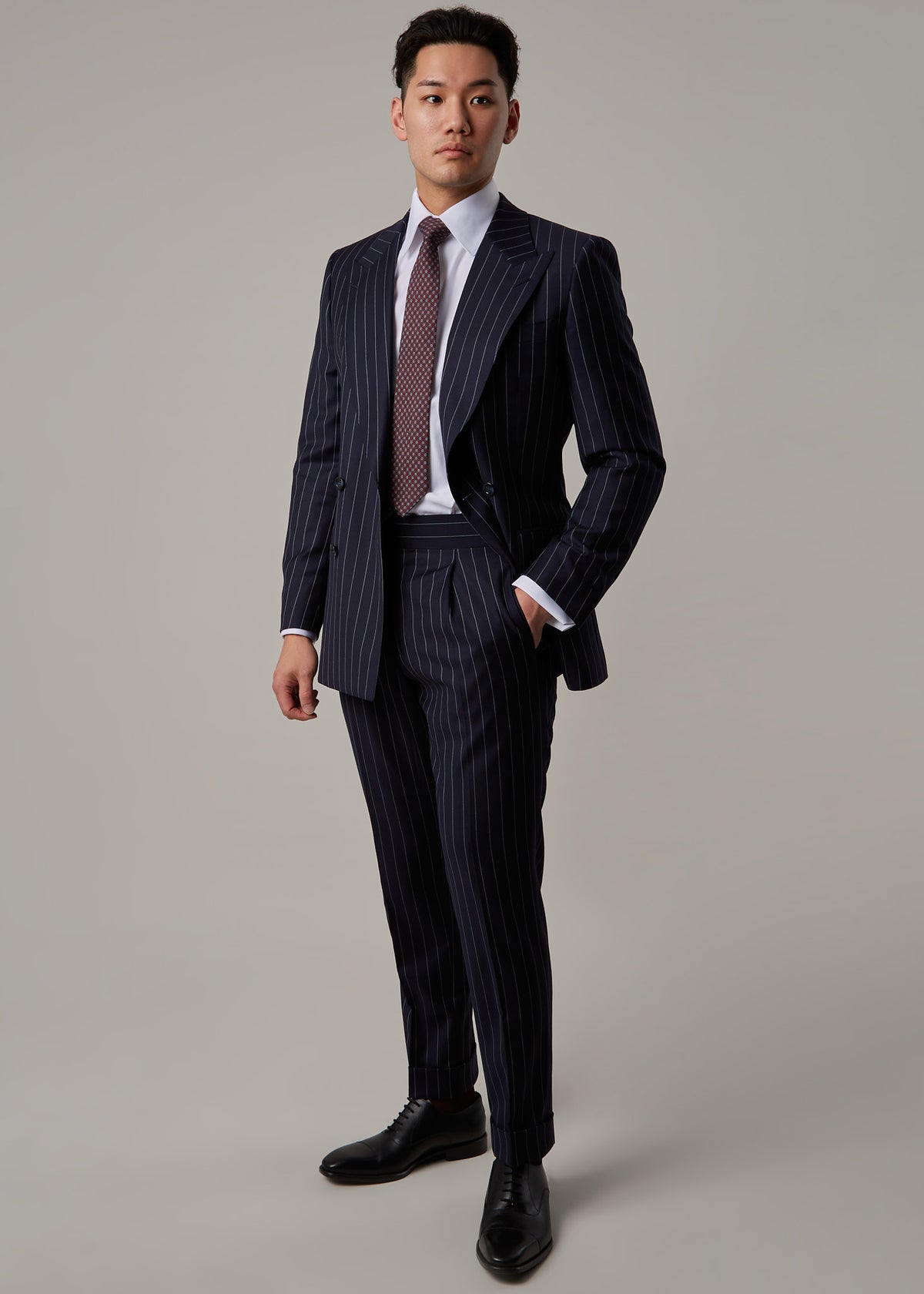 Greenwich Pinstripe Suit, full length view with body angled and hand in pocket