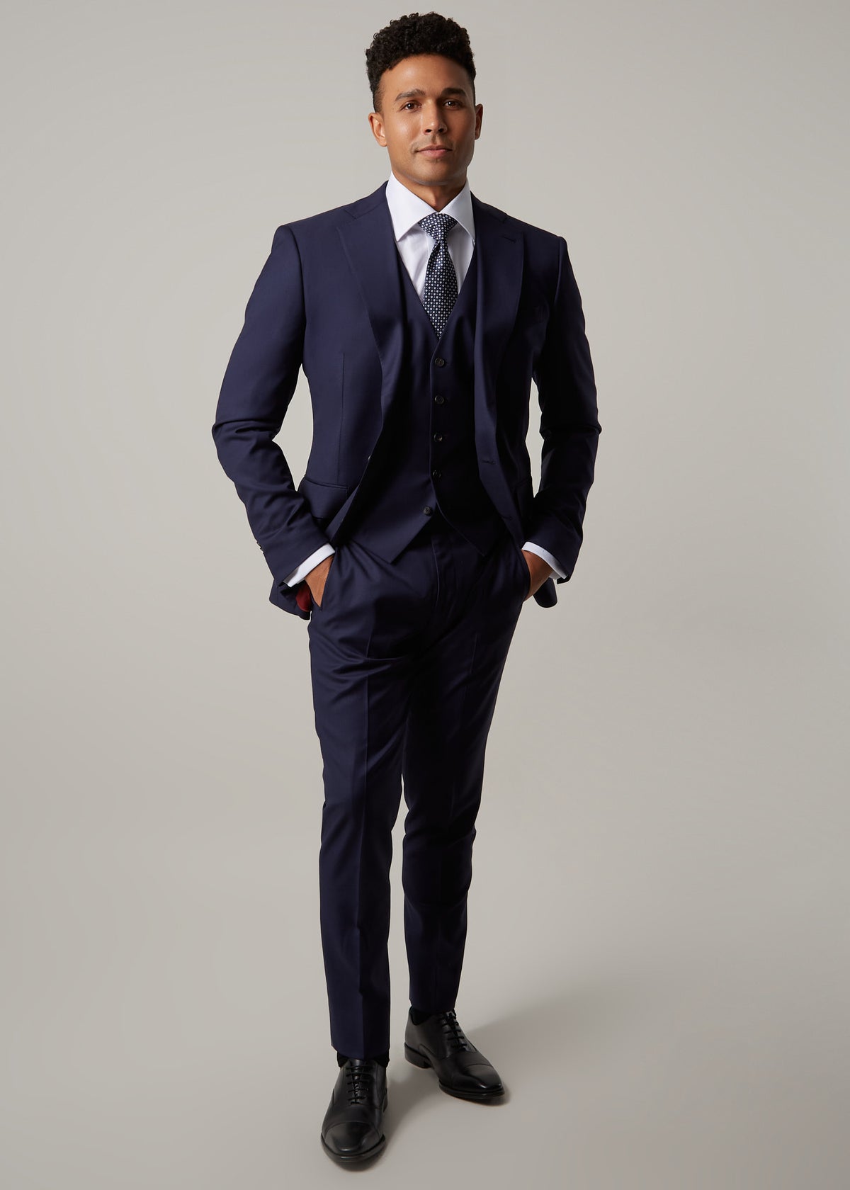 Rialto Royale Navy Suit three-piece worn with a patterned tie, full-length front view