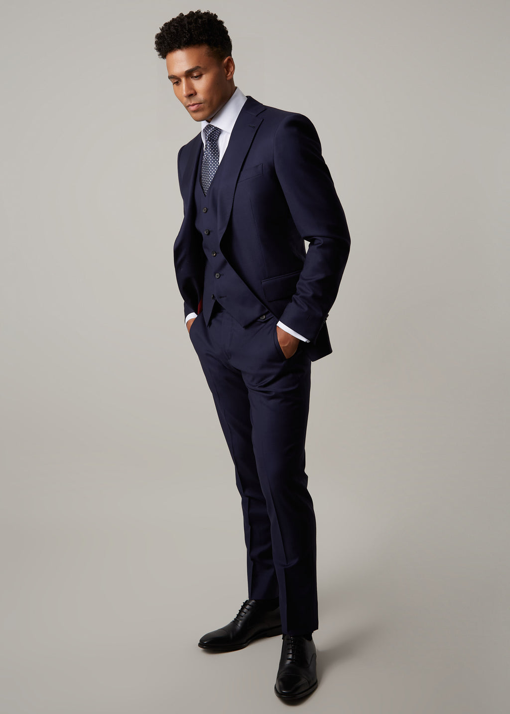 Rialto Royale Navy Suit three-piece, three-quarter angle, model looking down