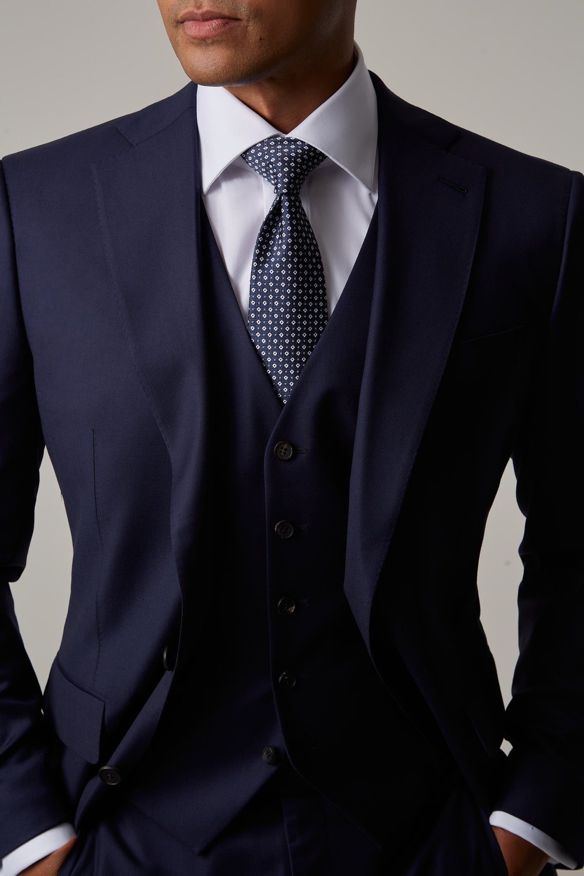 Close-up of the Rialto Royale Navy Suit collar, tie knot and waistcoat buttons