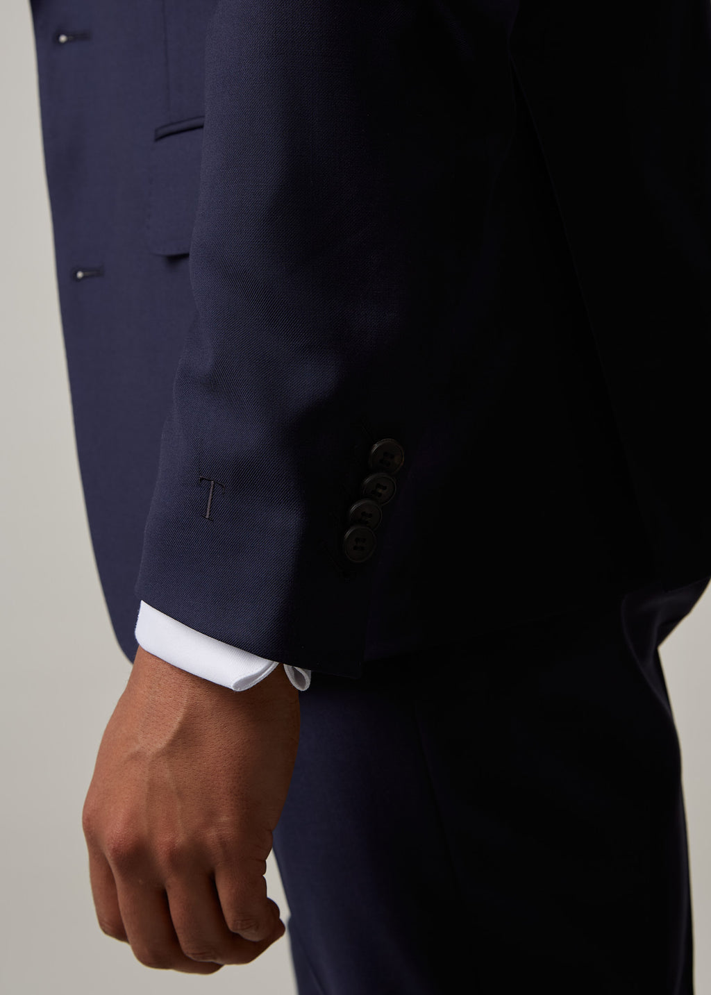 Close-up of the Rialto Royale Navy Suit sleeve cuff buttons with a T monogram