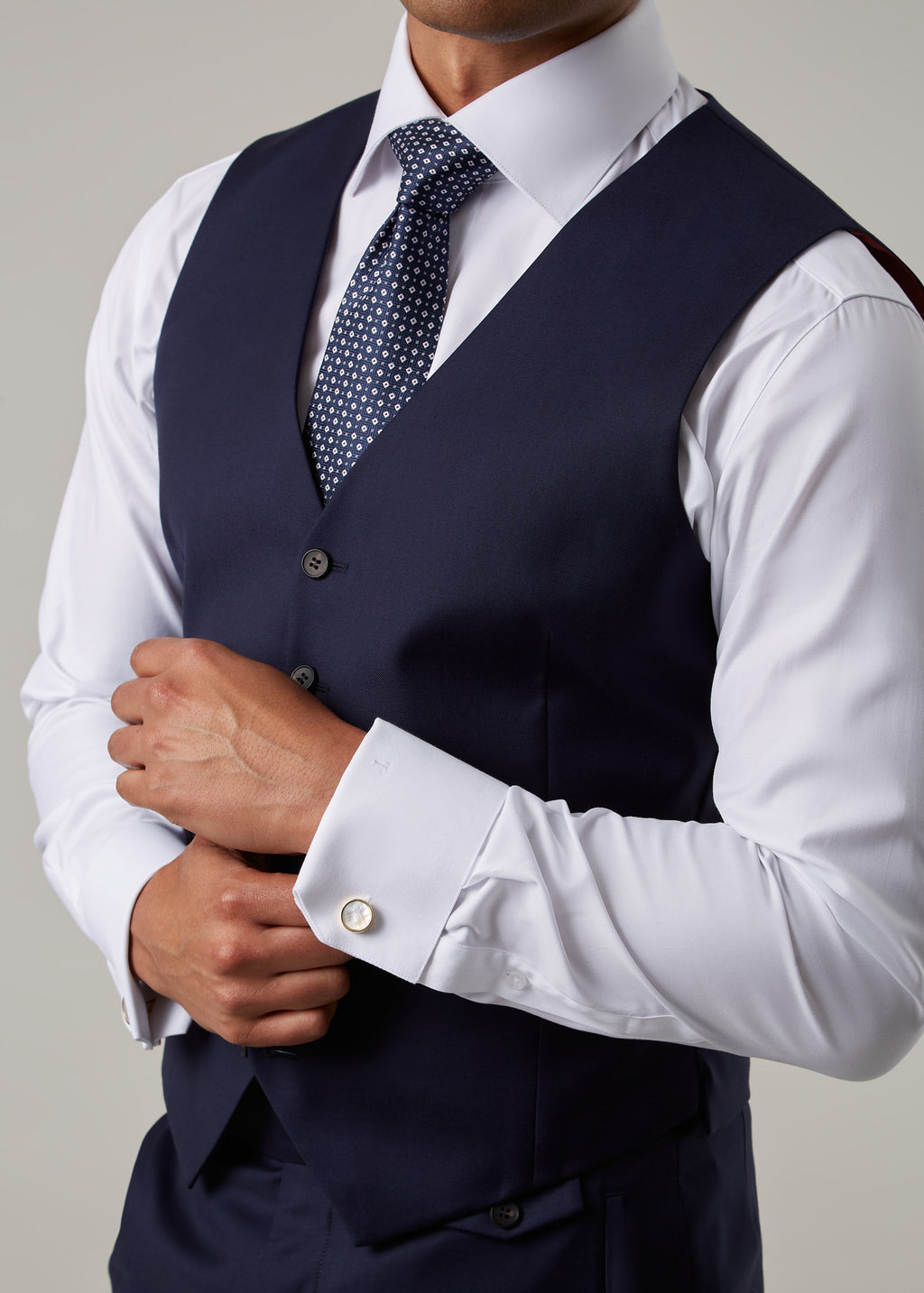 Close-up of the Rialto Royale Navy Suit waistcoat, hand adjusting the shirt cuff