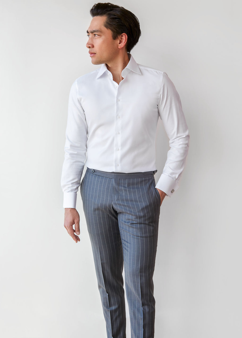 Our Perfect White Shirt tucked into grey trousers, full-length front view