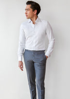 Our Perfect White Shirt tucked into grey trousers, full-length front view