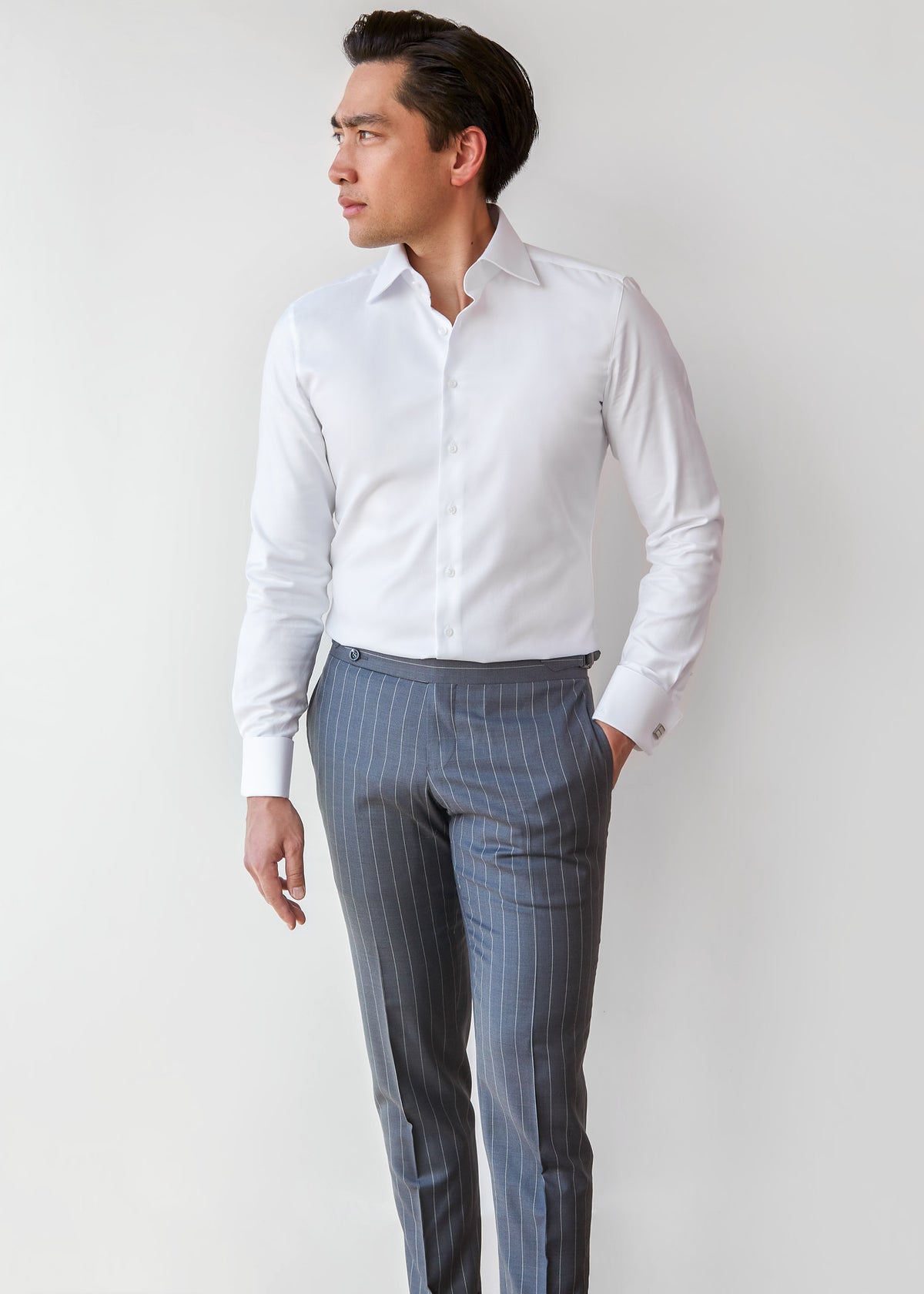 Our Perfect White Shirt tucked into grey trousers, full-length front view