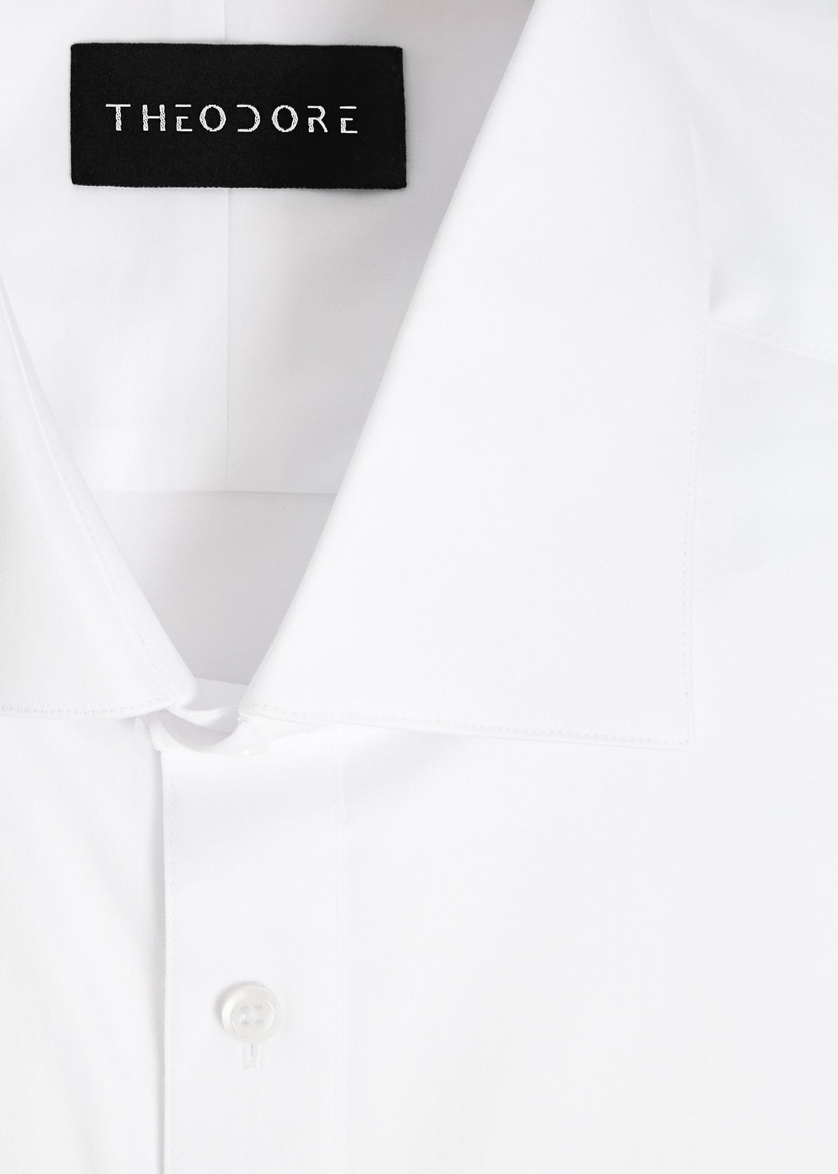 Our Perfect White Shirt collar close-up with the Theodore label, folded flat