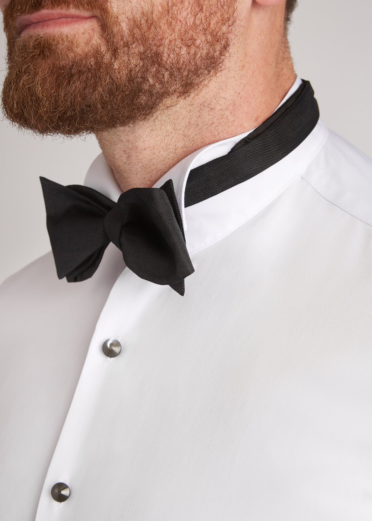 Black Ribbed Silk Bow Tie worn close-up against a wing collar