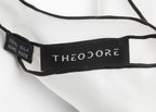 Lyon Pocket Square in white silk, close-up of the woven Theodore label