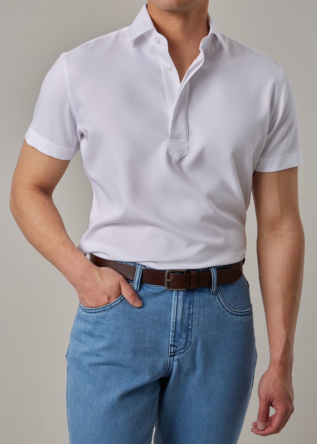 White Short Sleeve Popover Shirt, close chest crop with a hand tucking into the pocket