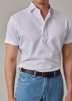 White Short Sleeve Popover Shirt, close-up chest view on a model with jeans and belt