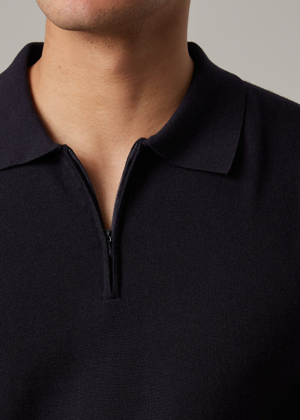 Close-up of the quarter-zip collar and zip pull on the Fireball Zip Polo Navy
