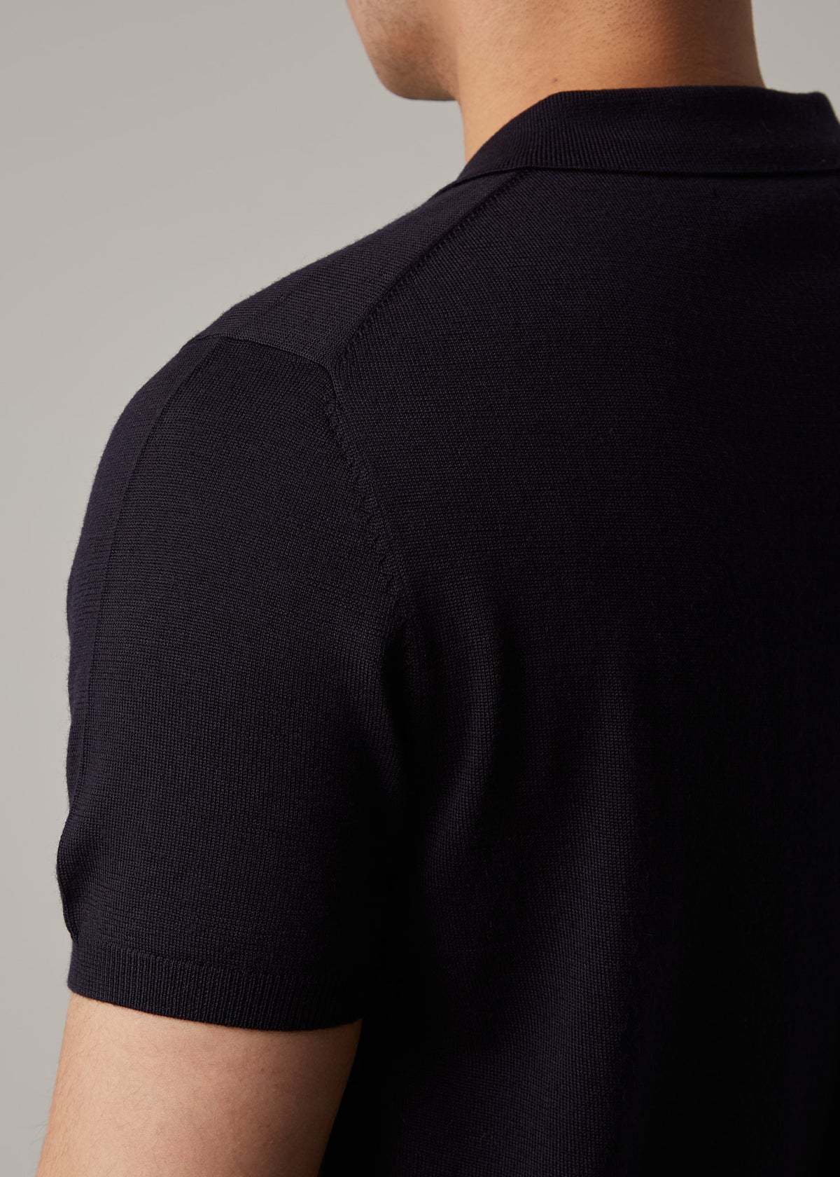 Back shoulder close-up of the Fireball Zip Polo Navy showing the knit texture