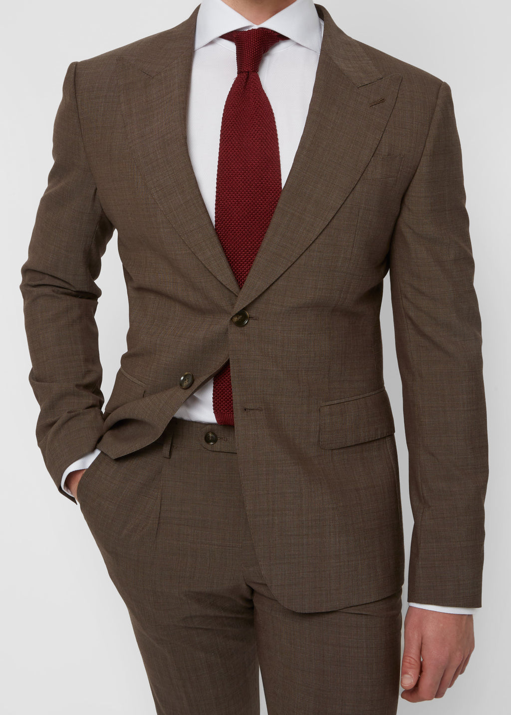 Close-up of the Madison Avenue Brown Suit jacket front, hand in pocket