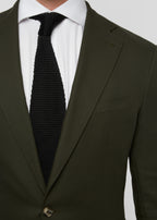 Greenwich Village Olive Suit close-up of lapel, button and tie centred on chest
