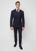 Savile Row Navy Pinstripe Suit worn with a rust tie, front view, hands in pockets