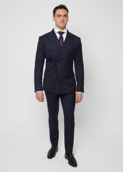 Savile Row Navy Pinstripe Suit worn with a rust tie, front view, hands in pockets