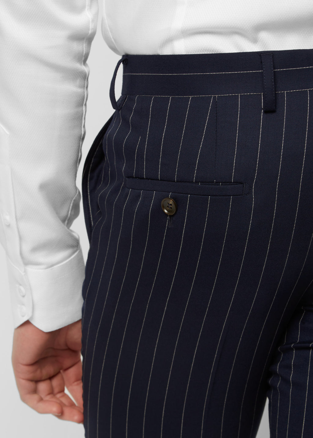 Close-up of the Savile Row Navy Pinstripe Suit peak lapel and purple tie knot