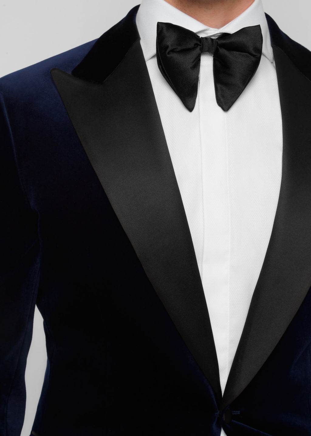 Midnight Luxe Navy Tuxedo, close-up of the satin peak lapels and bow tie knot