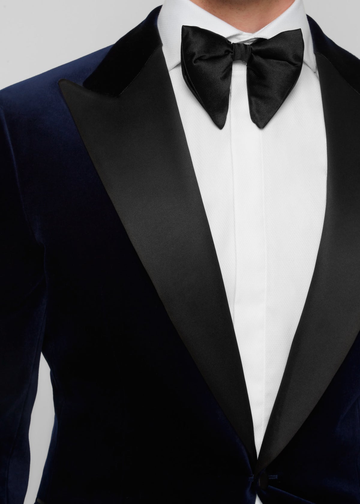Midnight Luxe Navy Tuxedo, close-up of the satin peak lapels and bow tie knot