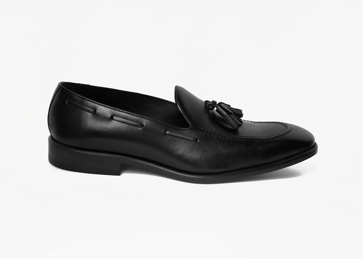 Black box calf tassel loafer, close side profile showing the tassel detail