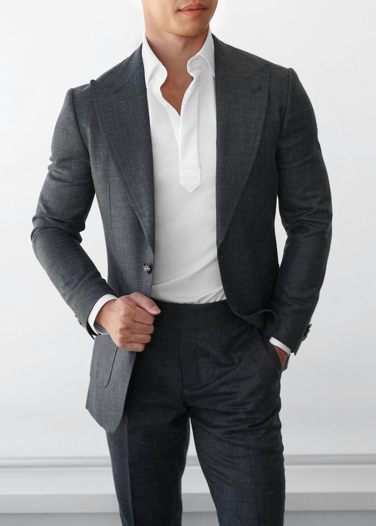 Martin Place Charcoal Linen Blend Suit, close-up of a model tugging the lapel