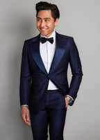 Cannes Navy Tuxedo, a smiling model faces forward with hand in pocket