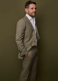 Devonshire Olive Suit jacket worn open over a white shirt, side profile on a model