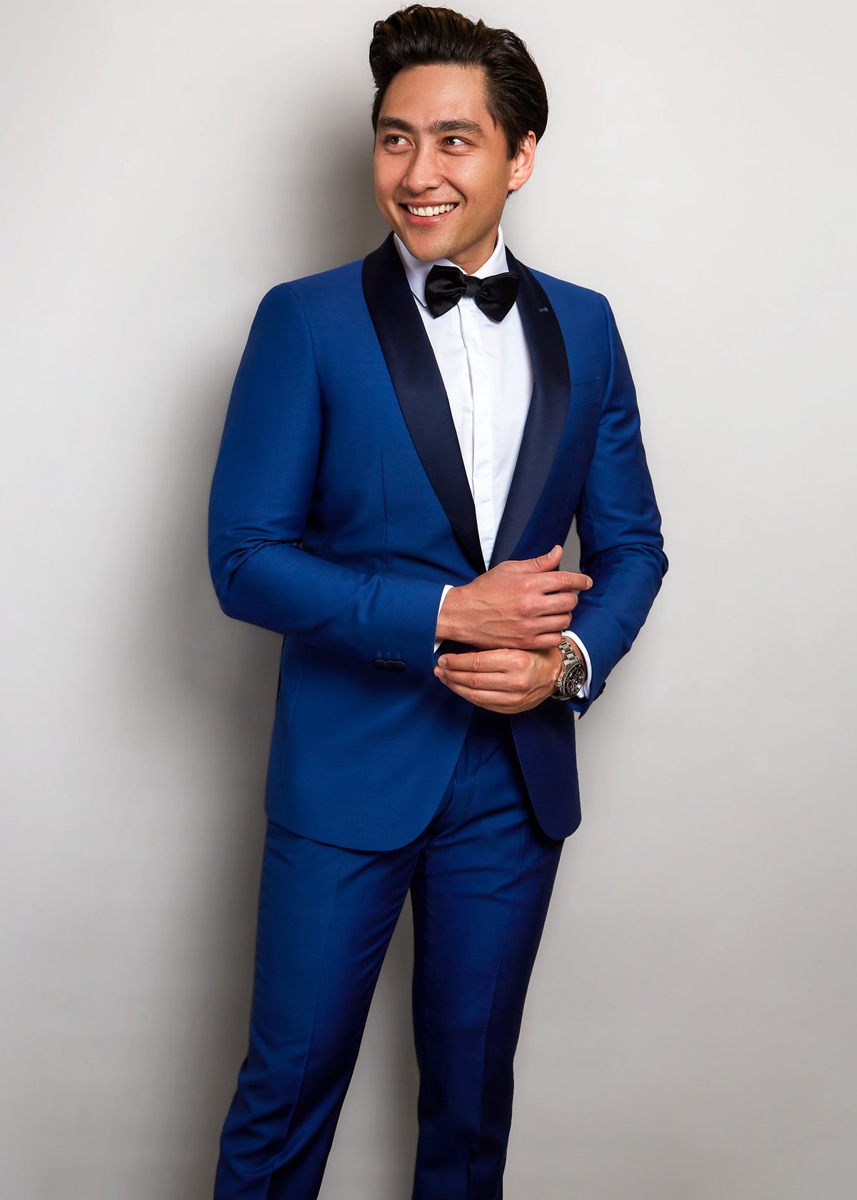 Monaco Navy Tuxedo with black satin shawl lapel, worn by a smiling model