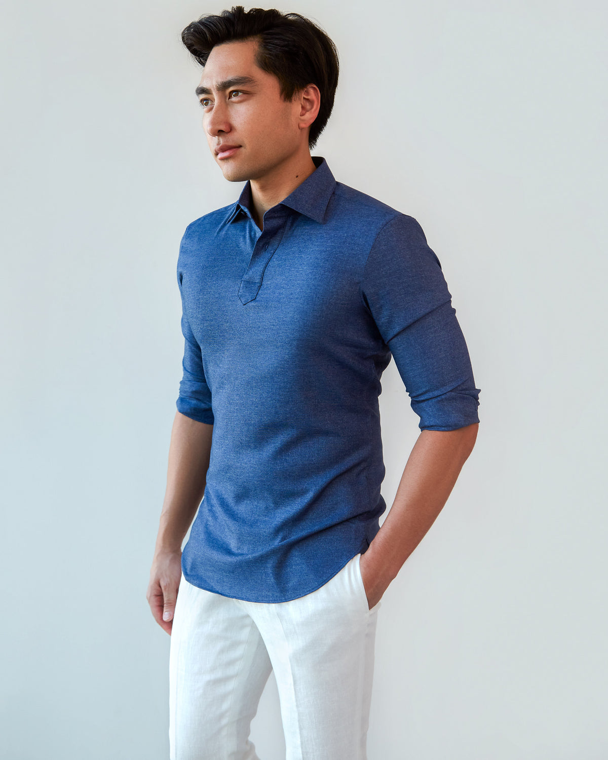Denim Popover Shirt, three-quarter view with sleeves rolled and a hand in the pocket